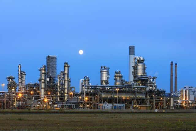 Petrochemical plant illuminated at twilight