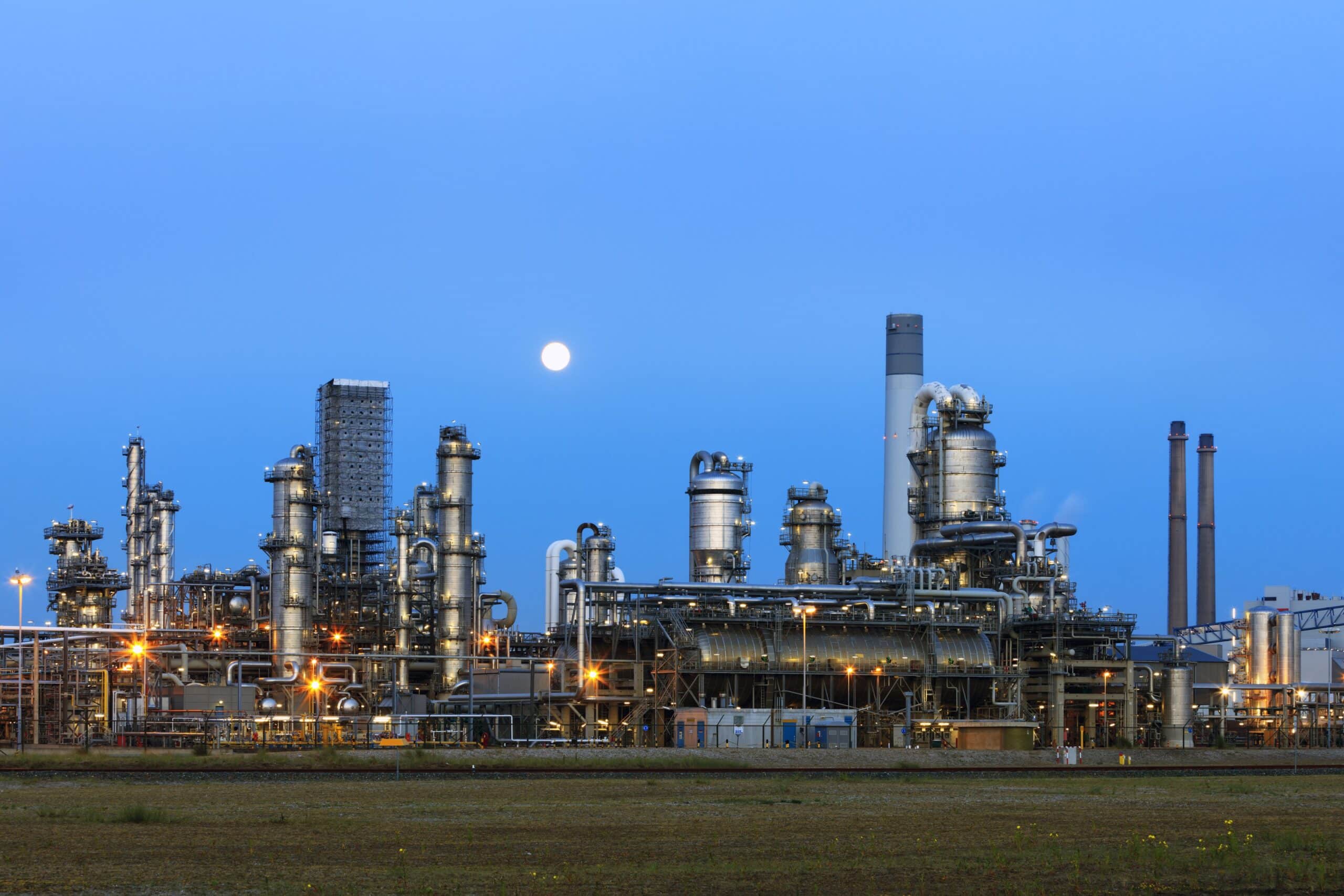 Petrochemical plant illuminated at twilight